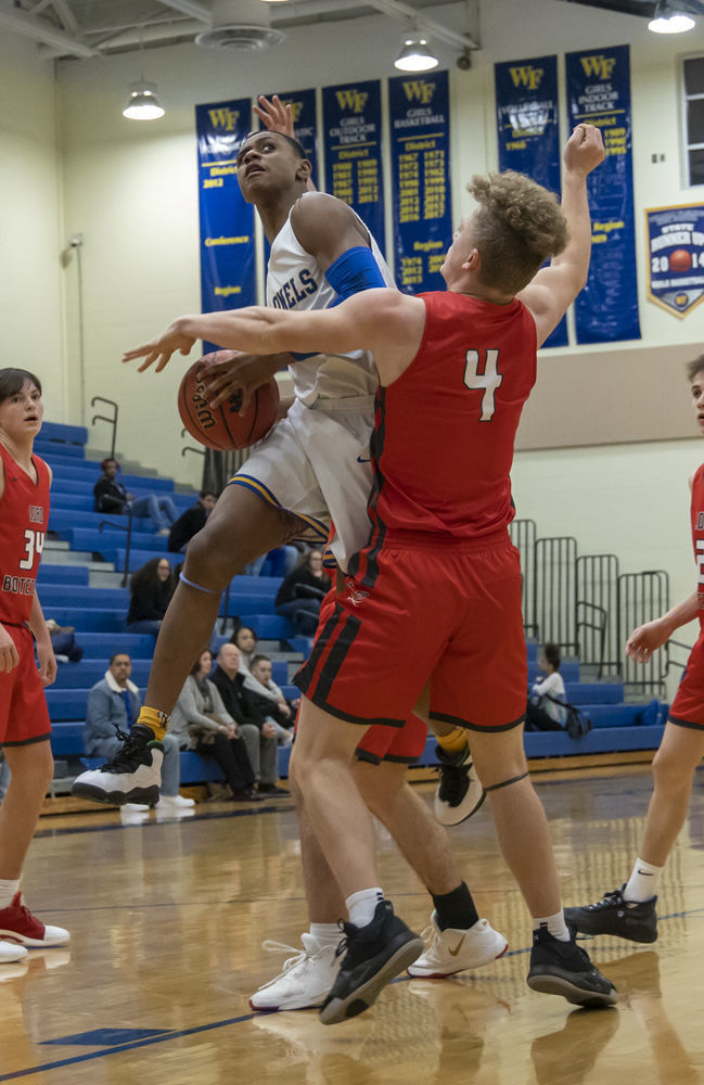 William Fleming's (24) Donovan St.Juste drives to the basket as Lord Botetourt's (4) Kyle Arnholt tries to defend.